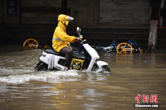 资料图：外卖小哥通过积水路段。<a target='_blank' href='http://www.chinanews.com/'>中新社</a>记者 刘冉阳 摄